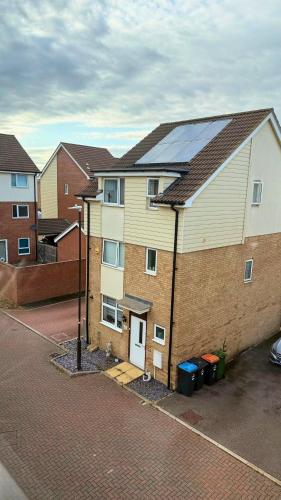 a house with a solar panel on top of it at Ensuite Private Cosy Space Near the Bus Station in Broughton