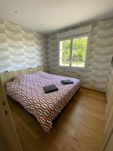 a bedroom with a bed with two towels on it at La maison normande in Rots