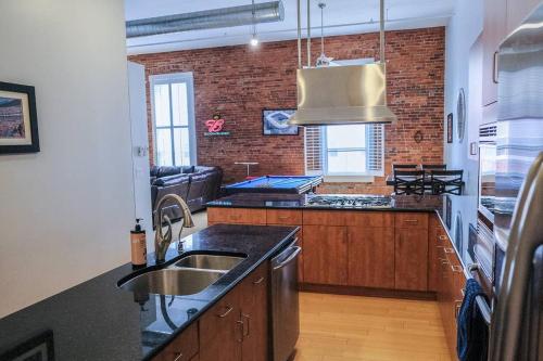 a kitchen with a sink and a counter top at 1800 Sq Ft Loft Downtown Near Convention Center in Indianapolis
