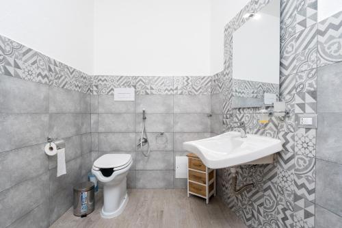 a bathroom with a sink and a toilet at Casa Regina Margherita in Loculi