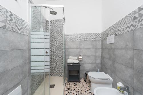 a bathroom with a toilet and a shower and a sink at Casa Regina Margherita in Loculi