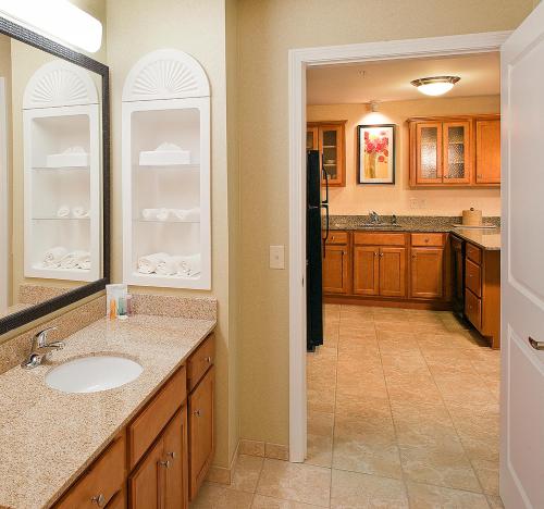 a large bathroom with a sink and a kitchen at White River Inn & Suites in White River Junction