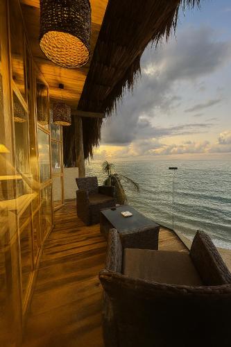 a restaurant with a view of the ocean at RCH LUXURY HOTEL & POOL in Dibulla