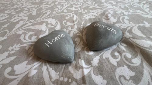 two rocks with writing on them on a bed at 100 m de la mer, Sauna, Wifi in Mers-les-Bains