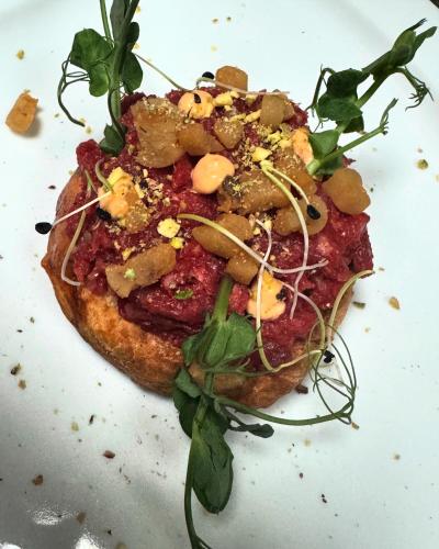 a pizza sitting on top of a white plate at Pension & Restaurant Atmosféra in Loket