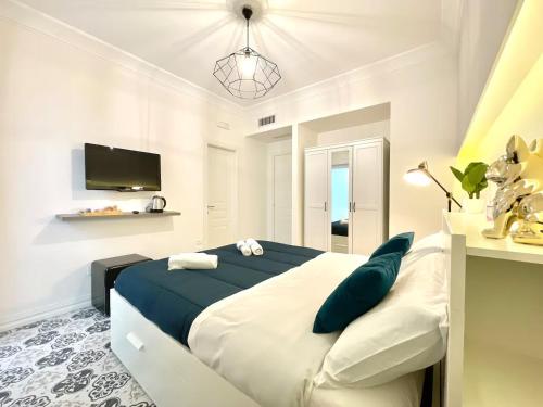 a bedroom with a large bed and a tv at Lecce Diamond - 200mq in centro città con terrazza privata in Lecce