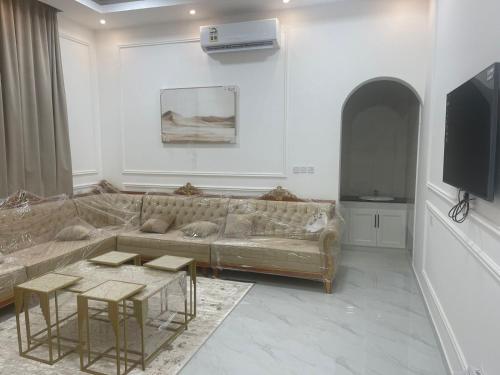 a living room with a couch and a tv at Villa awqad salalah in Salalah
