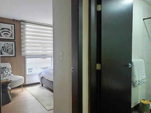 a room with a door leading to a bedroom at Apartment - 2Bedrooms - QueenBed - Balcony - Parking - 7thFLOOR in Quito