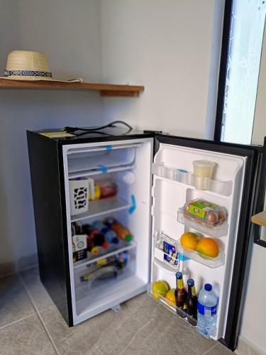 a refrigerator with its door open in a kitchen at Capibara-Glamping Cabaña in La Mesa
