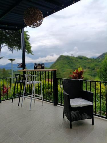 a balcony with a table and chairs and a view at Capibara-Glamping Cabaña in La Mesa
