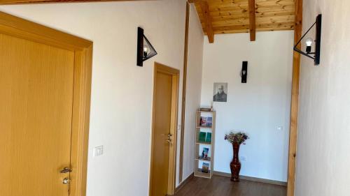 a room with a hallway with a vase on the wall at Tringa Guesthouse - Mrizi i Zanave in Fishtë