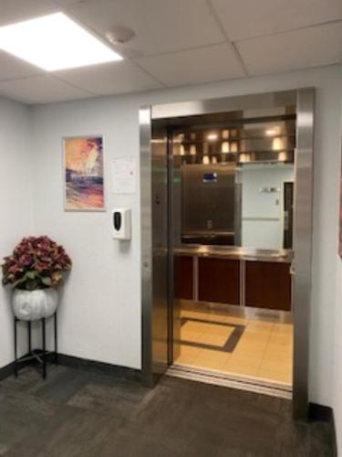 a room with a kitchen with a potted plant at Studio 6 Toronto - Mississauga with Kitchenettes in Mississauga