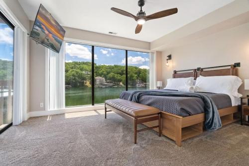 Un dormitorio con una cama y una ventana grande. en Lake Life Location with Serenity, en Osage Beach