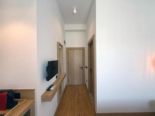 a hallway with a door and a tv on a wall at Casa Vagabundo Boutique Hotel - Adults Only in Alanya