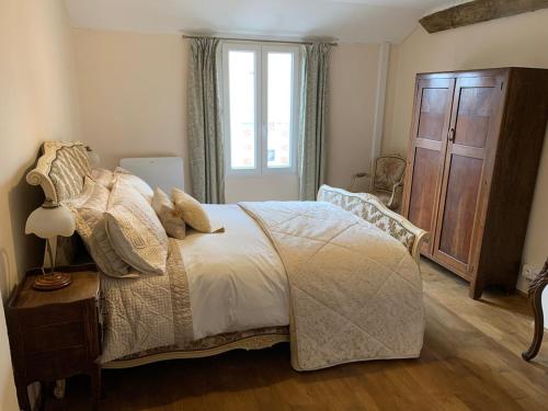 a bedroom with a bed and a window at La Petite Maison, Perrou, Normandy, Orne in Perrou