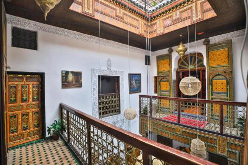 a room with a balcony with a ceiling at Riad Fes Zayna in Fès