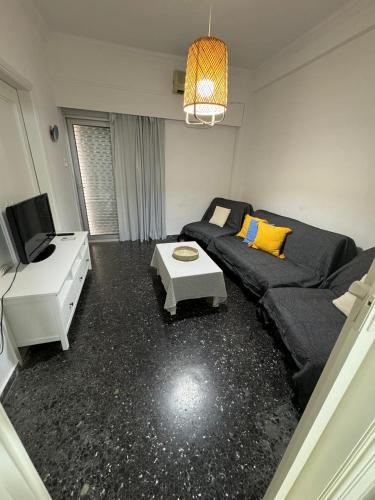 a living room with a couch and a table at EVE'S HOUSE 2 in FRONT OF THE BEACH in Loutraki