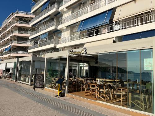a building with a restaurant with tables in it at EVE'S HOUSE 2 in FRONT OF THE BEACH in Loutraki