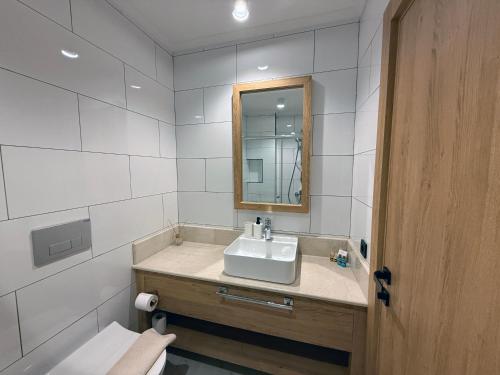 a bathroom with a sink and a mirror and a toilet at Casa Vagabundo Boutique Hotel - Adults Only in Alanya