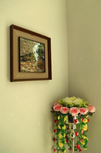a painting of a horse on a wall with flowers at Royal Suites Muscat in Ma‘ābīlah