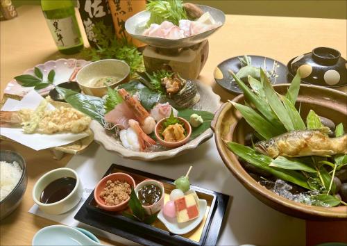 a table topped with different types of food at 民宿食事処 たつのや in Shirahama