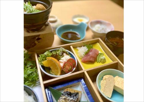 a table with plates of food and bowls of food at 民宿食事処 たつのや in Shirahama