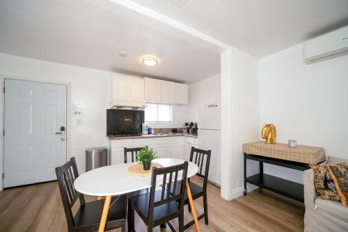 a kitchen and dining room with a white table and chairs at Cozy 2BR2BA Guest House in Alhambra in Alhambra