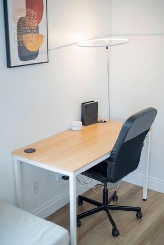 a wooden desk with a chair and a laptop on it at Cozy 2BR2BA Guest House in Alhambra in Alhambra