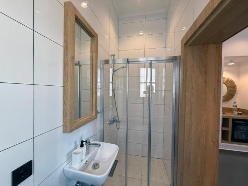 a bathroom with a sink and a glass shower at Casa Vagabundo Boutique Hotel - Adults Only in Alanya