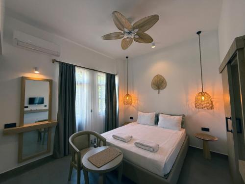 a bedroom with a bed with two chairs and a ceiling at Casa Vagabundo Boutique Hotel - Adults Only in Alanya