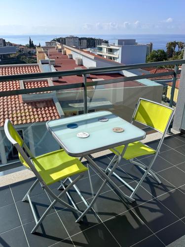 a table and two chairs on a balcony at Heart of Madeira in Funchal