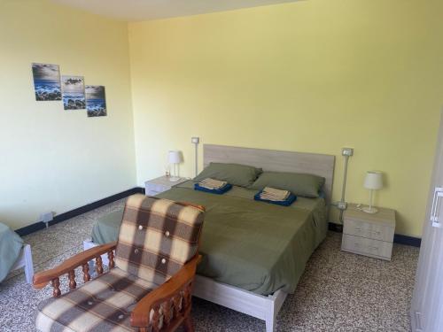 a bedroom with a bed and a chair at La Quercia in San Benedetto Val di Sambro