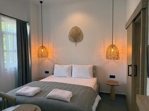 a bedroom with a bed with two towels on it at Casa Vagabundo Boutique Hotel - Adults Only in Alanya