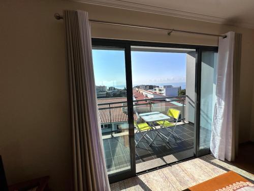 a room with a balcony with a view at Heart of Madeira in Funchal