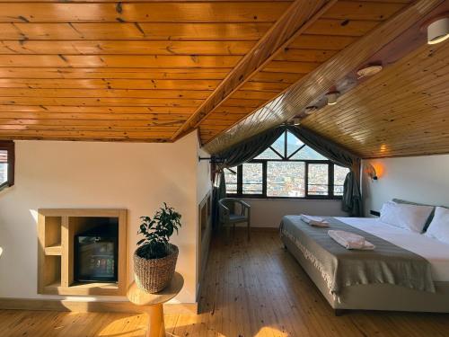 a bedroom with a bed and a fireplace at Casa Vagabundo Boutique Hotel - Adults Only in Alanya