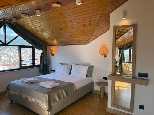 a bedroom with a bed with a wooden ceiling at Casa Vagabundo Boutique Hotel - Adults Only in Alanya
