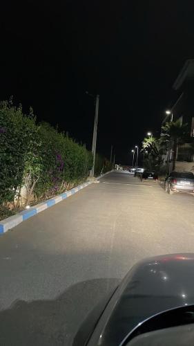 a car driving down a street at night at Cosy apartment in Bouznika in Bouznika