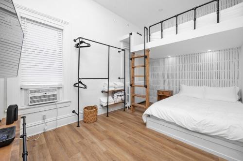 a bedroom with a bunk bed and a desk at Downtown Adams in Sandusky