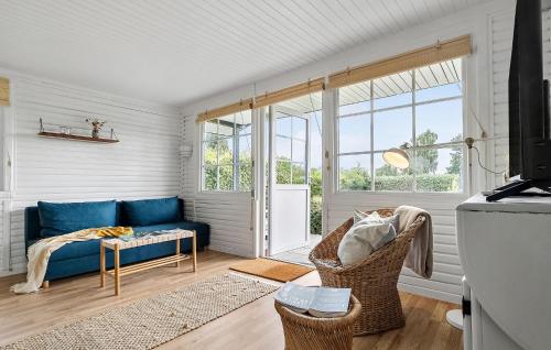 a living room with a blue couch and a window at Pet Friendly Home In Aabenraa With Wifi - F07406 in Aabenraa