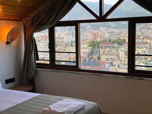 a bedroom with a view of a city from a window at Casa Vagabundo Boutique Hotel - Adults Only in Alanya