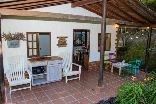 a patio with chairs and a table and a mirror at Mini ISABELITA in El Retiro