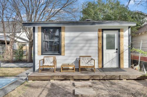 a tiny house with two chairs on a porch at Walkable Private Guest House Studio with Pickleball Court in Austin
