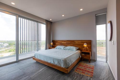 a bedroom with a bed and a large window at Ocean view condo - Beach, pool & jacuzzi! in Cancún
