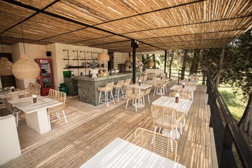 a restaurant with tables and chairs on a wooden deck at La Pausa Hotelbistro in Guatapé