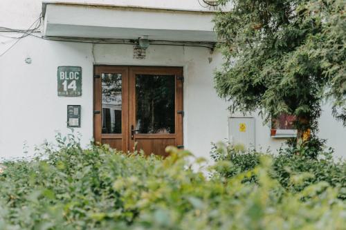 a door to a building with a sign on it at A&Zs Residence in Gheorgheni