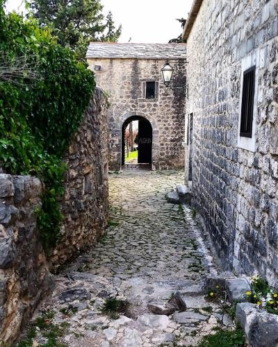 an alley in an old stone building with a doorway at Holiday house between the sea and lakes in Grubine
