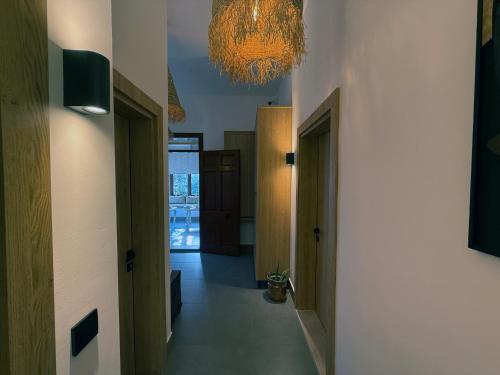 a hallway with a chandelier on the ceiling and a hallway with doors at Casa Vagabundo Boutique Hotel - Adults Only in Alanya