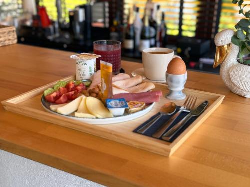 a tray with a plate of food on a table at Casa Vagabundo Boutique Hotel - Adults Only in Alanya