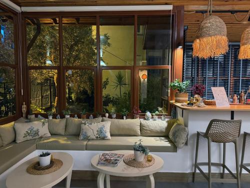 a living room with a couch and two tables at Casa Vagabundo Boutique Hotel - Adults Only in Alanya