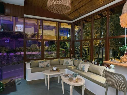 a living room with a couch and tables at Casa Vagabundo Boutique Hotel - Adults Only in Alanya